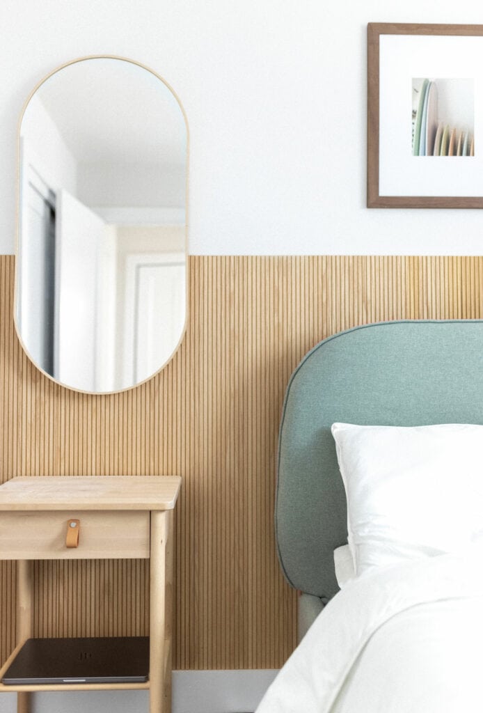 Bedroom with a focus on the headboard and white wall colour behind it