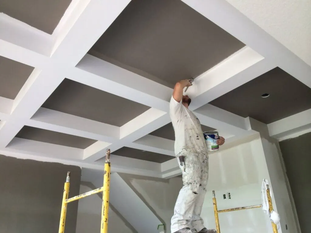 Professional painting company painting the ceiling of a bedroom